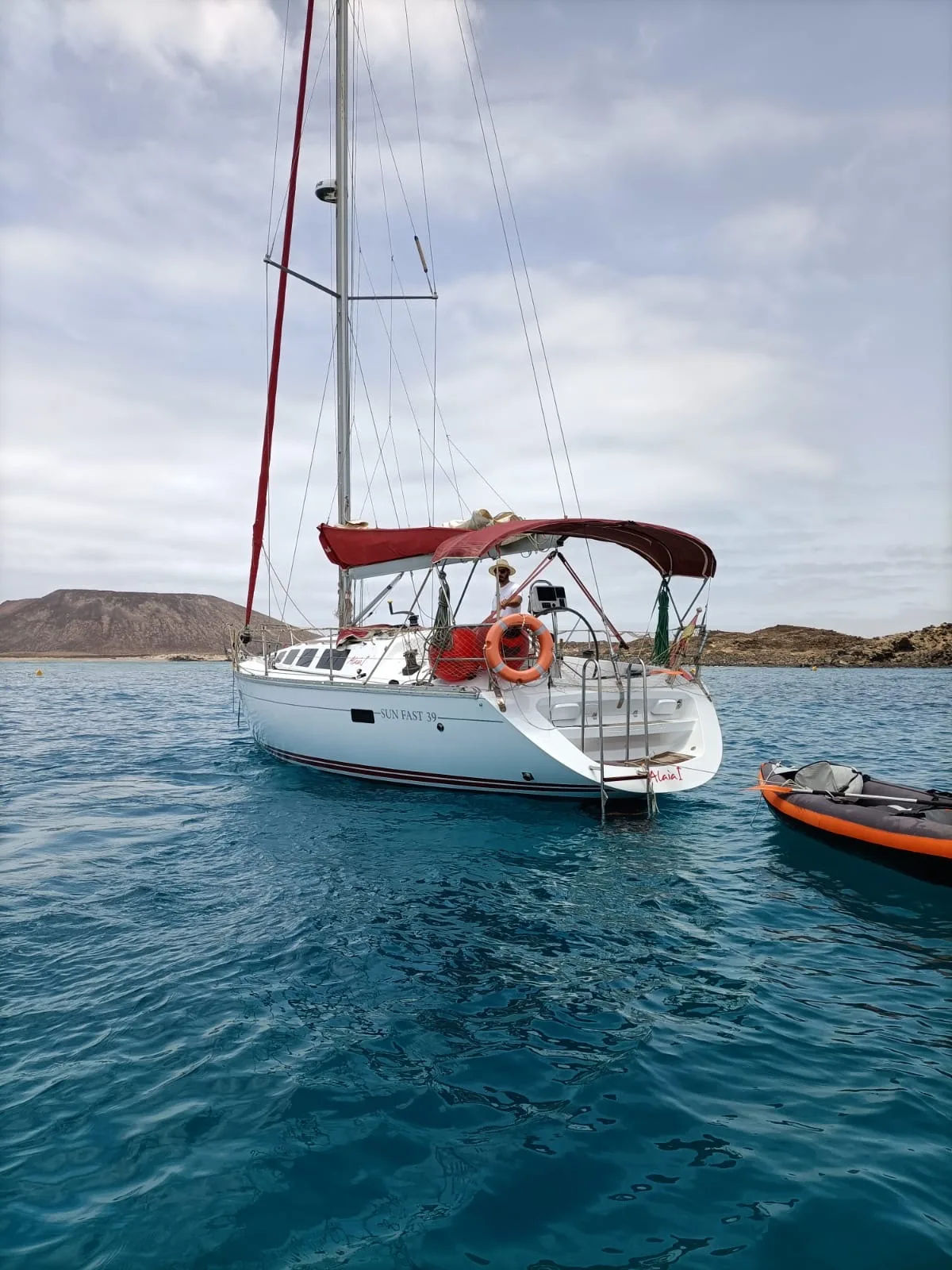 El ALAIA fondeado en una cala de aguas turquesas junto a un kayak